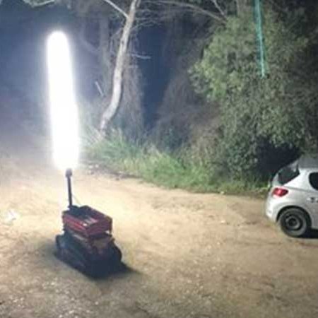 Rolalight deployed on its base lighting a forest road at night